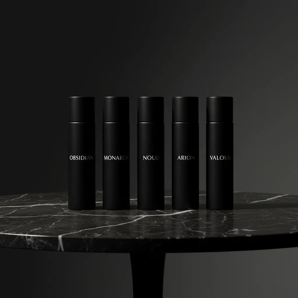 Men’s luxury perfume discovery set arranged on a stone surface