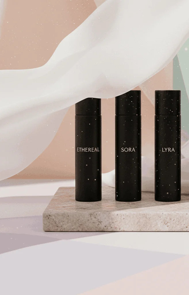 Women’s luxury perfume discovery set styled as an elegant gift with florals and ribbon